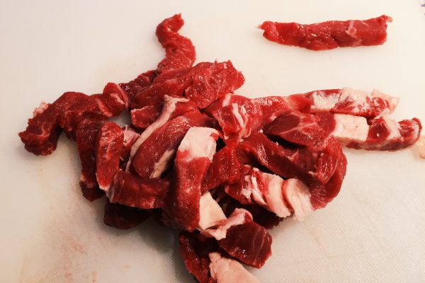 Sliced bite sized strips of rib-eye steak for Mexican fajitas