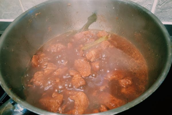 Pork poaching in adobo sauce