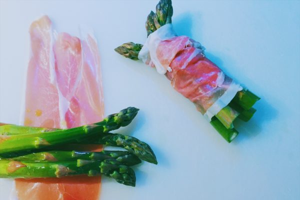 Roll the asparagus in Parma ham, oil and season