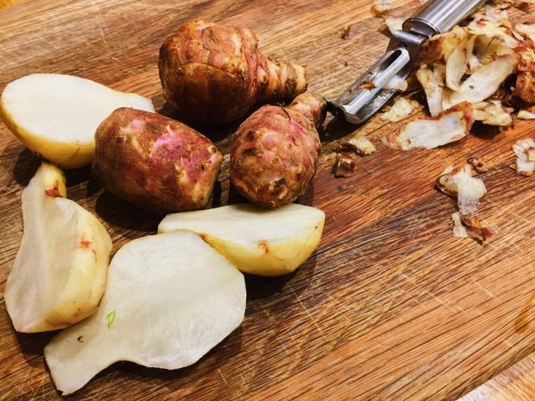 Peel and slice in half Fartichokes for roasting | National Dish